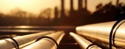 golden sunset in crude oil refinery with pipeline system